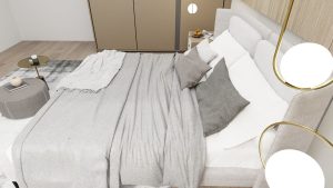 Rustige slaapkamer in zachte greige en taupe tinten met grijs beddengoed en gouden lamp
